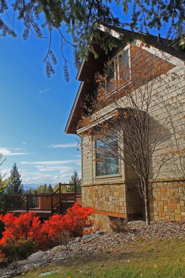 view of side of home with a deck