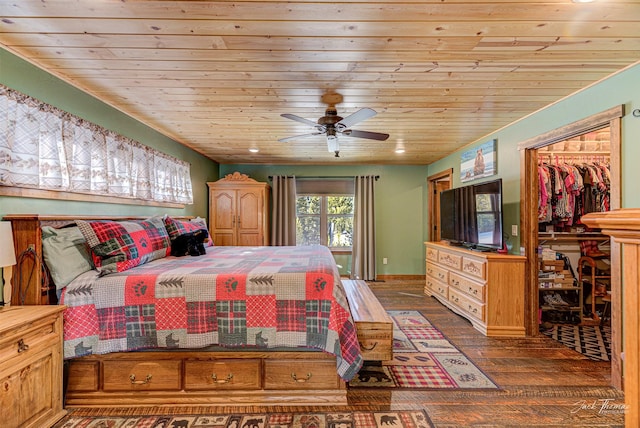 bedroom featuring wood ceiling, a walk in closet, dark hardwood / wood-style floors, and ceiling fan