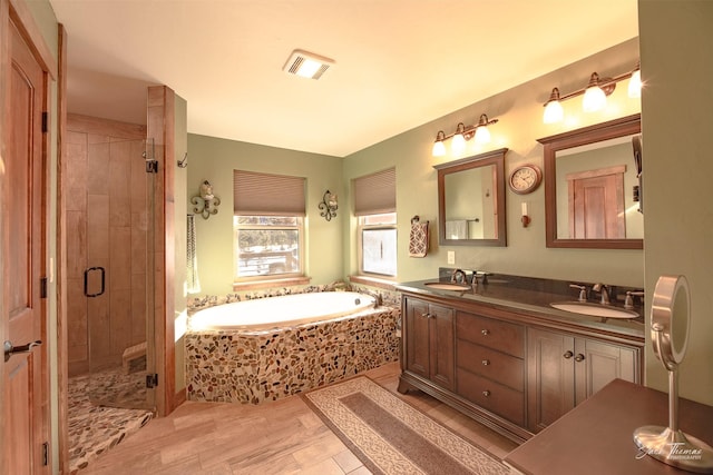 bathroom with vanity and separate shower and tub