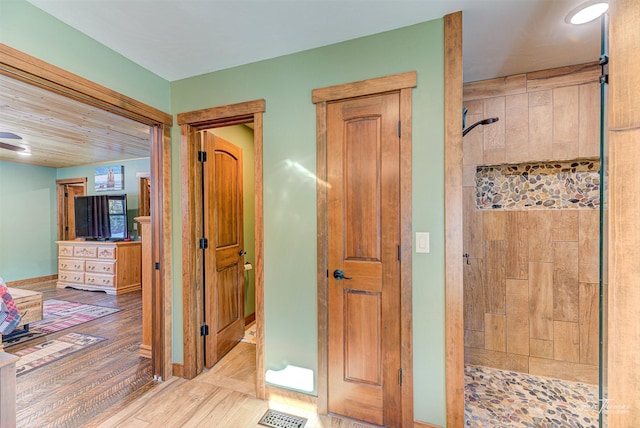 hallway with light hardwood / wood-style floors