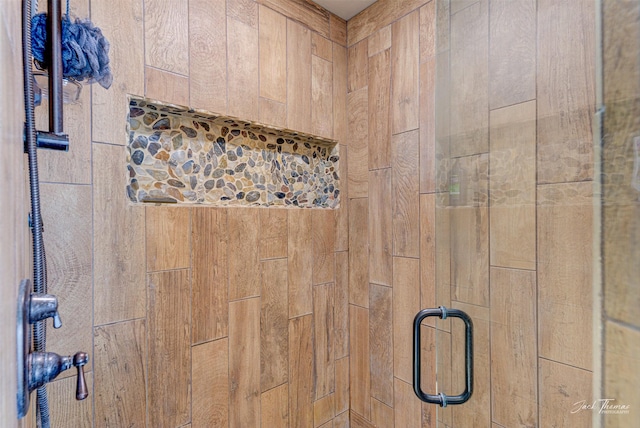 interior details featuring a shower with shower door