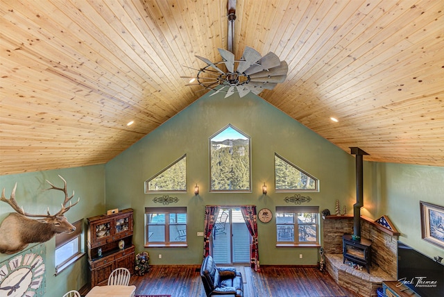 living room with wood ceiling, high vaulted ceiling, hardwood / wood-style floors, and a wood stove