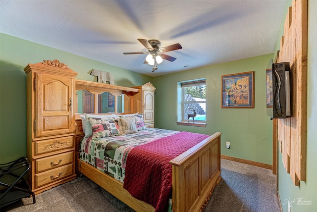 bedroom with ceiling fan and dark carpet