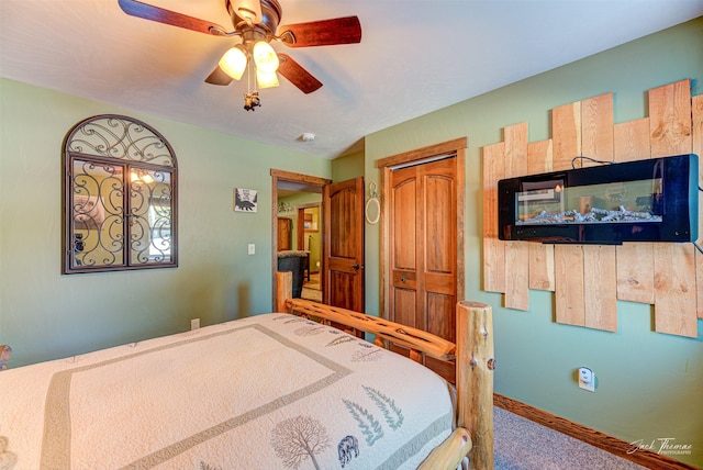 bedroom with ceiling fan, carpet flooring, and a closet