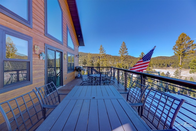 deck with a mountain view and grilling area