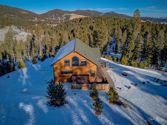 snowy aerial view featuring a mountain view