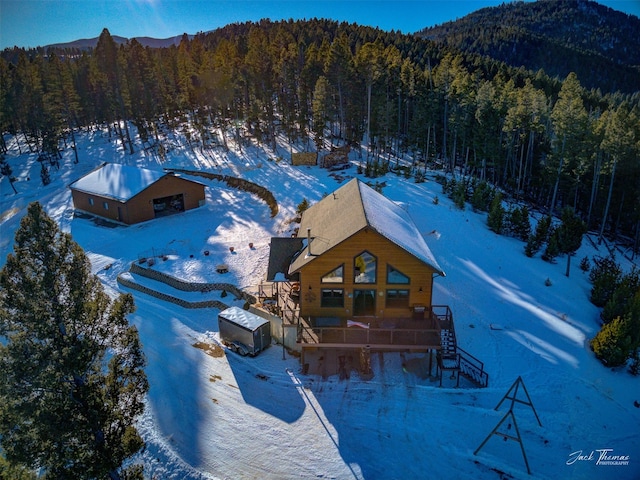 snowy aerial view featuring a mountain view