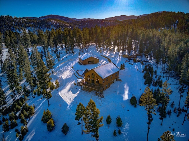 snowy aerial view featuring a mountain view