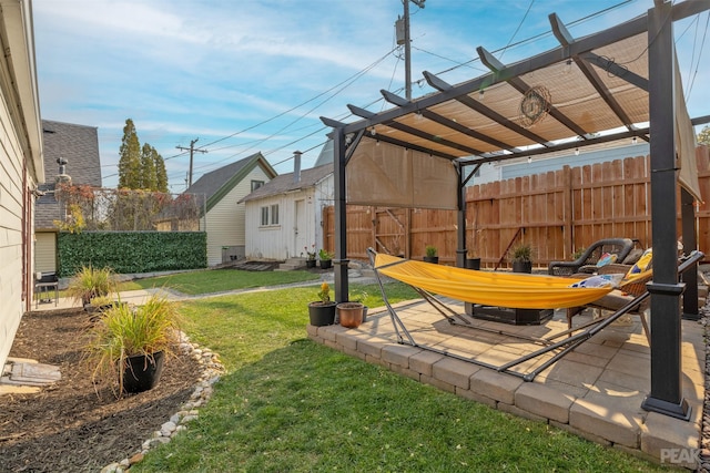 view of yard featuring an outbuilding, a pergola, and a patio