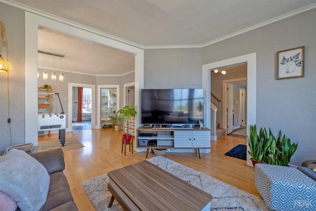 living room with ornamental molding and hardwood / wood-style floors