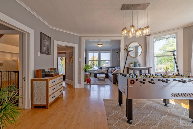 game room with crown molding and light hardwood / wood-style floors