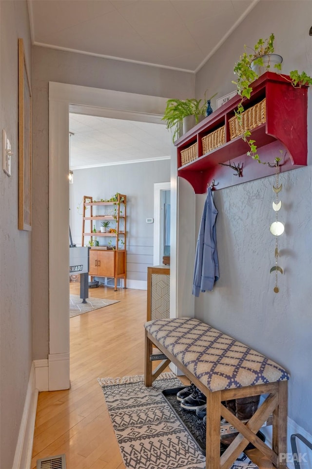 mudroom with hardwood / wood-style flooring and ornamental molding