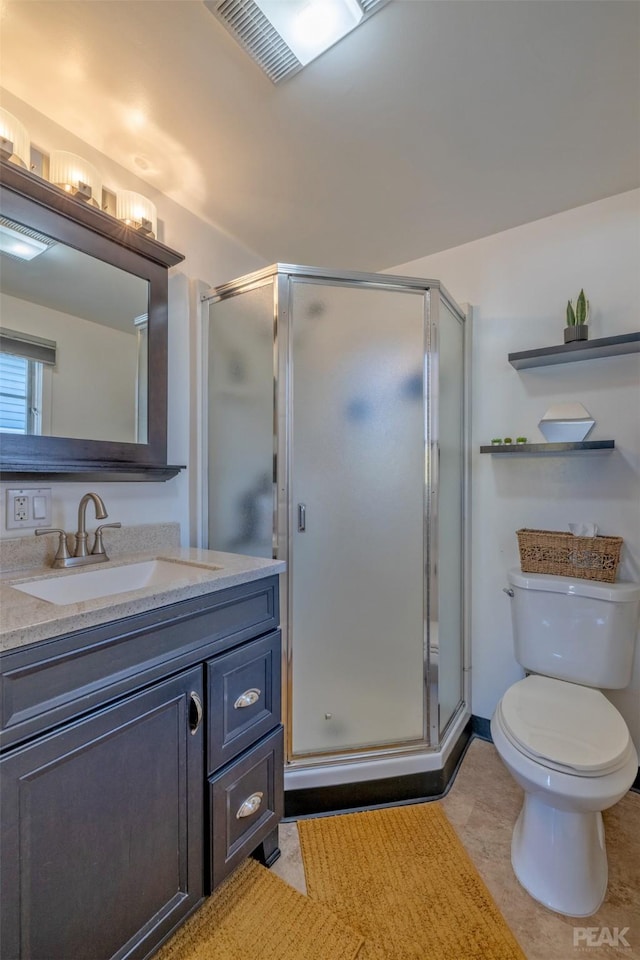 bathroom with an enclosed shower, vanity, and toilet