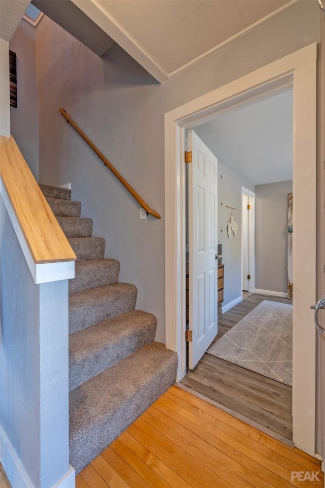 stairs featuring hardwood / wood-style flooring