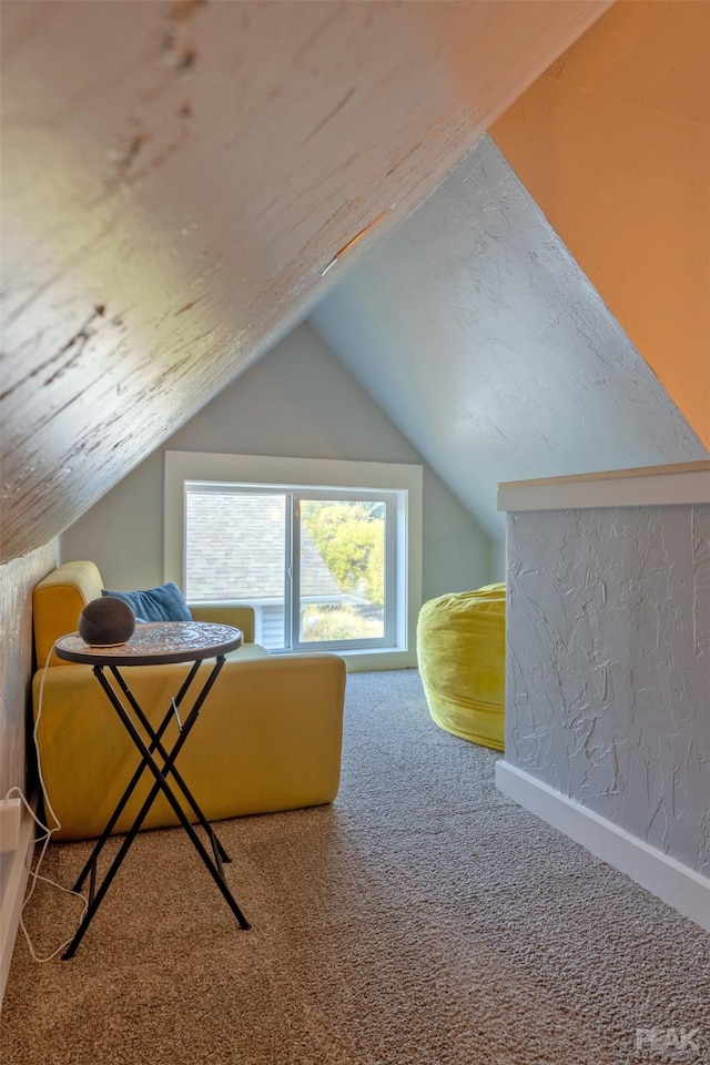 bonus room with lofted ceiling and carpet flooring