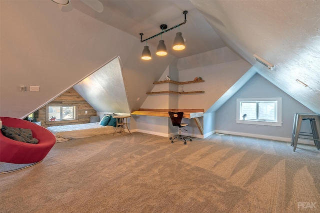 additional living space featuring vaulted ceiling, carpet flooring, and a textured ceiling