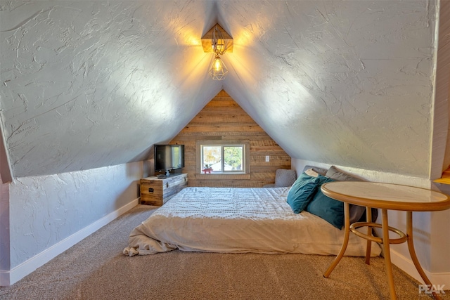 unfurnished bedroom with vaulted ceiling, carpet, and a textured ceiling