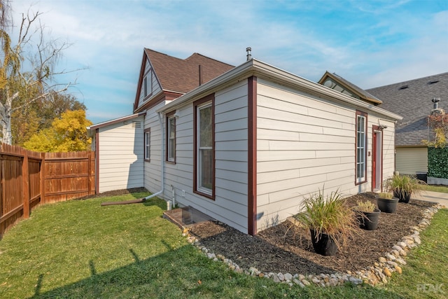 view of side of home featuring a yard