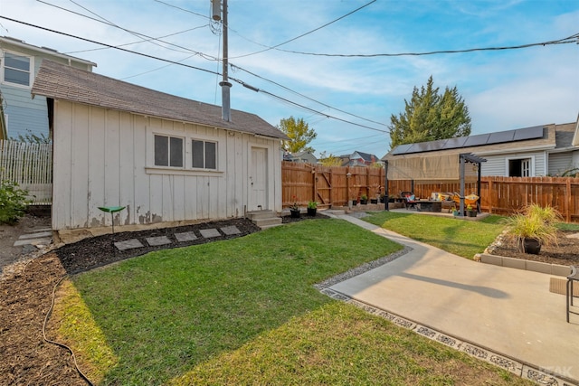 view of yard with an outdoor structure and a patio area