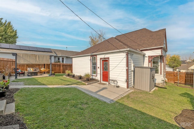 rear view of house featuring a storage shed, an outdoor hangout area, a patio, and a lawn