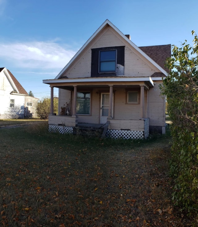 rear view of property featuring a porch