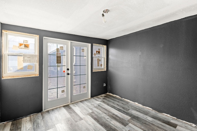 entryway featuring a textured ceiling and light wood-type flooring