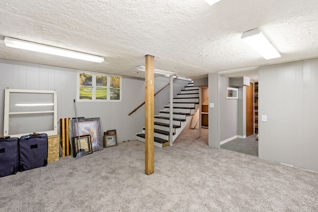 basement with carpet floors and a textured ceiling