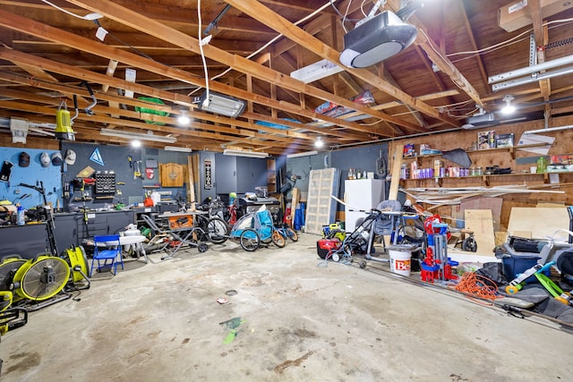 garage featuring white refrigerator and a workshop area