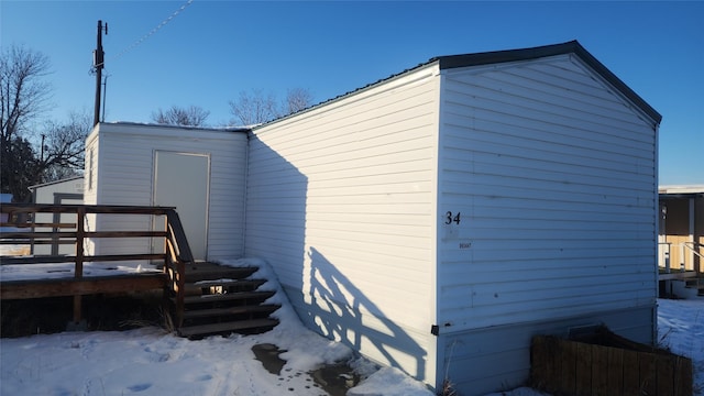 view of side of home with a wooden deck