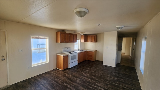 kitchen with dark wood-type flooring and white range with electric cooktop