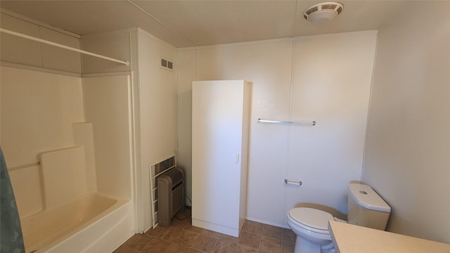 full bathroom with vanity, tile patterned floors, washtub / shower combination, and toilet