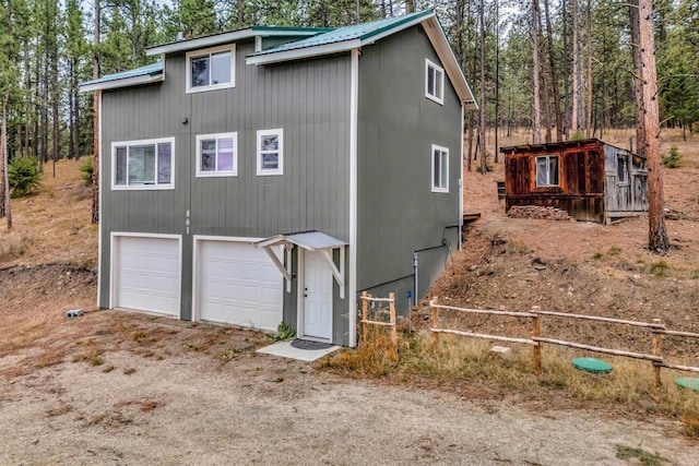 rear view of property featuring a garage