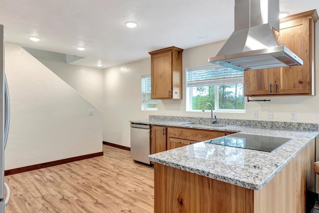 kitchen featuring sink, light hardwood / wood-style flooring, island exhaust hood, black electric stovetop, and light stone countertops