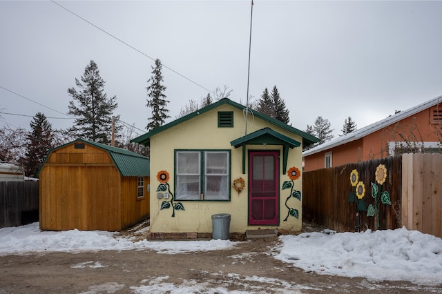 bungalow-style home with a storage shed