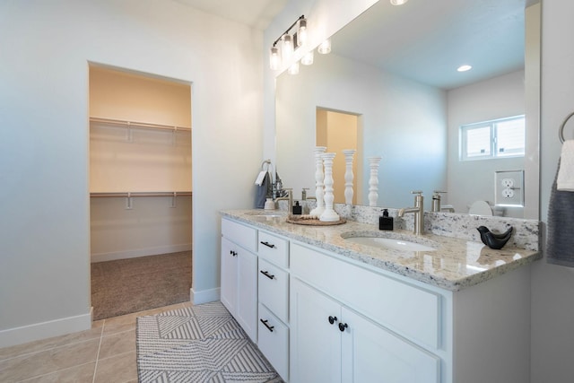 bathroom featuring tile patterned flooring and vanity