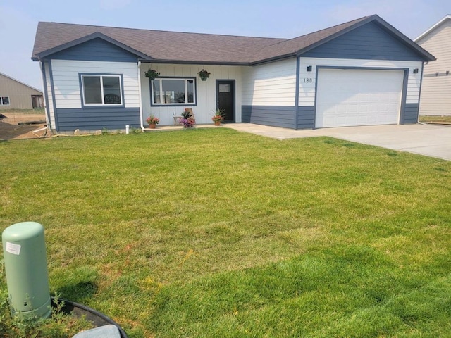 single story home with a garage and a front lawn