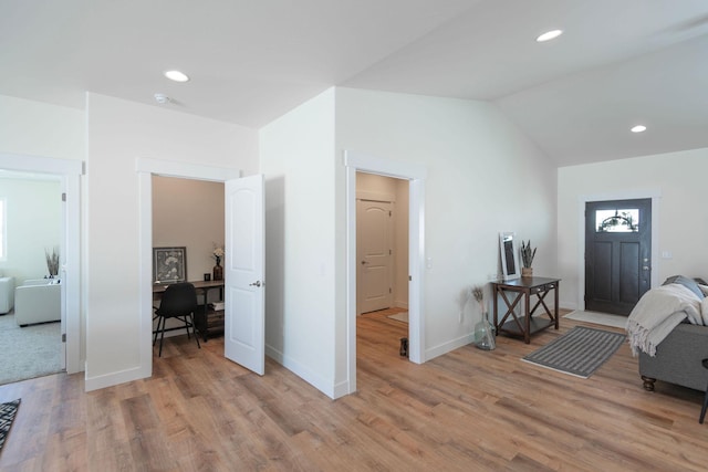 foyer featuring vaulted ceiling and light wood-type flooring