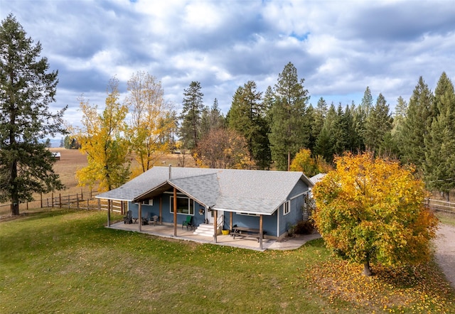 back of house with a patio area and a lawn