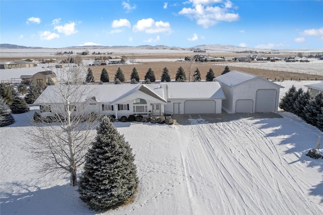 snowy aerial view featuring a mountain view