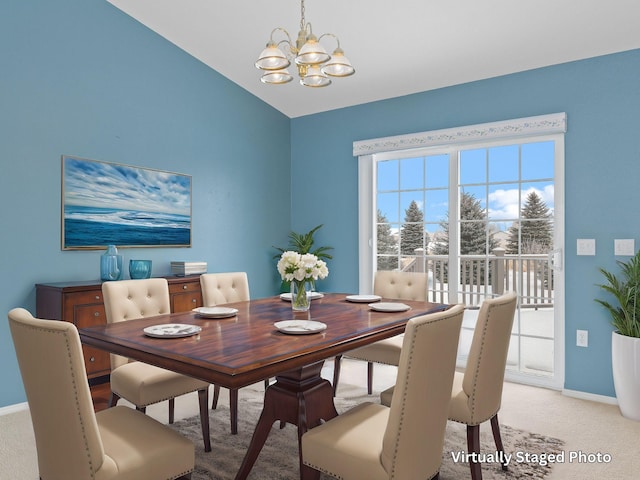 carpeted dining room featuring an inviting chandelier and vaulted ceiling