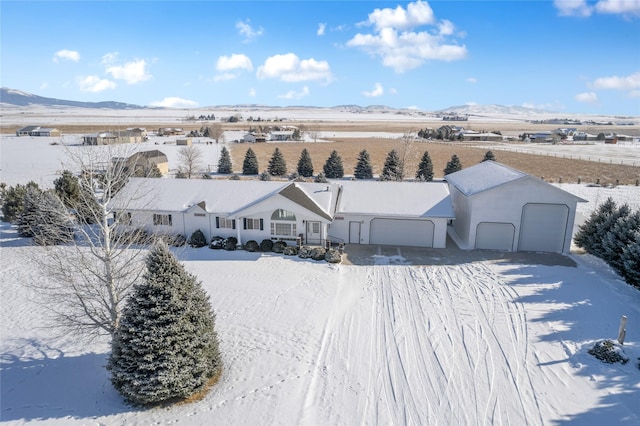 snowy aerial view with a mountain view