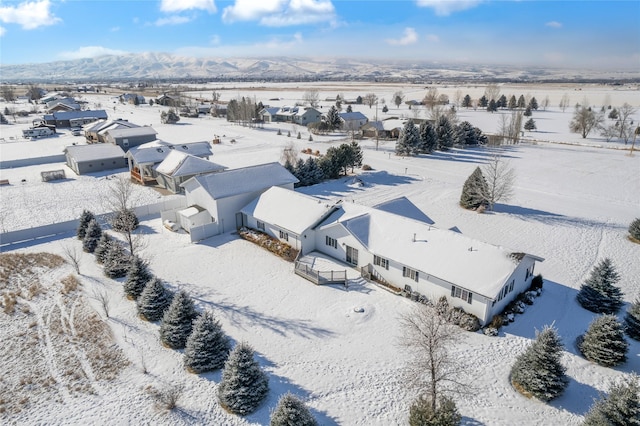 snowy aerial view featuring a mountain view