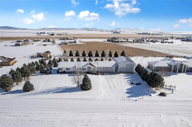 snowy aerial view with a mountain view