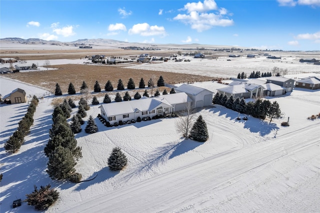 snowy aerial view featuring a mountain view