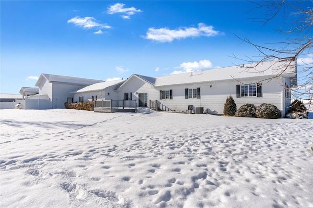 view of snow covered back of property