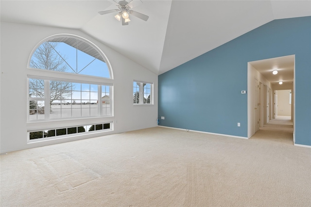 unfurnished living room featuring ceiling fan, high vaulted ceiling, and light carpet