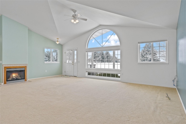 unfurnished living room featuring ceiling fan, carpet flooring, and high vaulted ceiling