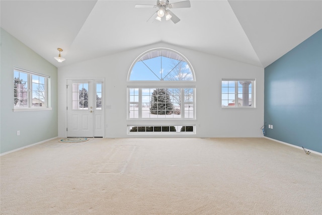 unfurnished living room with vaulted ceiling, ceiling fan, and carpet flooring