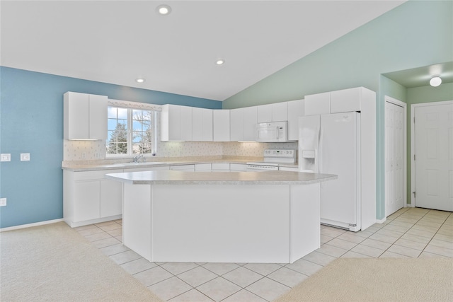 kitchen featuring light tile patterned flooring, lofted ceiling, white cabinetry, a kitchen island, and white appliances