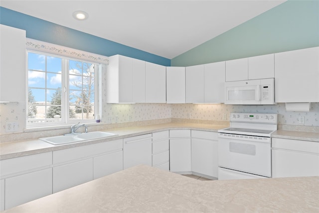 kitchen featuring vaulted ceiling, sink, white cabinets, and white appliances